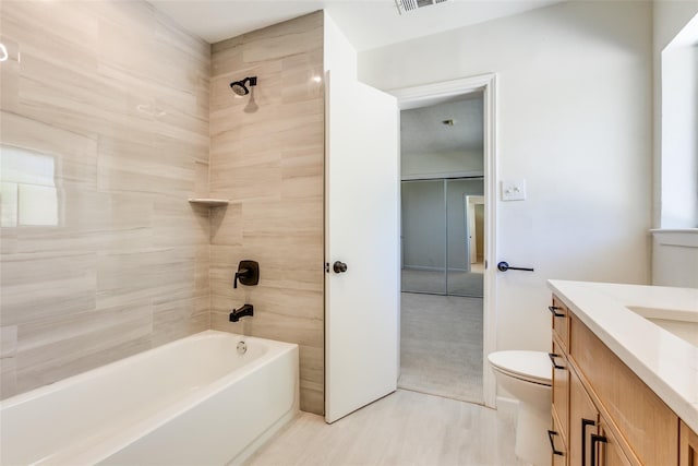 bathroom with vanity, shower / bathtub combination, visible vents, and toilet
