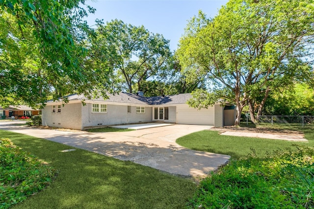 ranch-style house with a garage, fence, a front yard, and concrete driveway