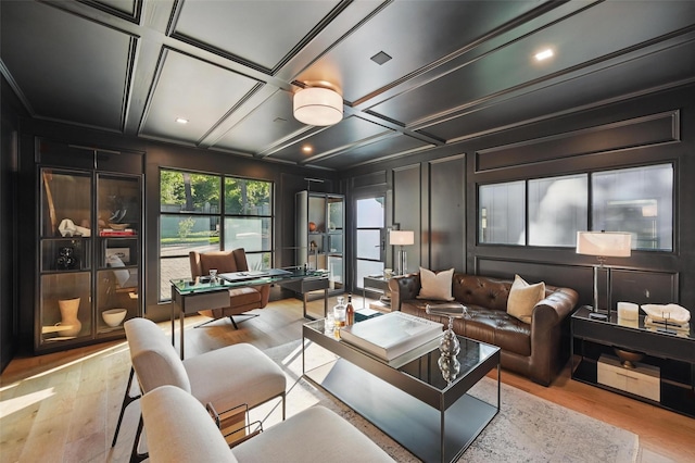living room with recessed lighting, wood finished floors, and a decorative wall