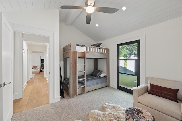 carpeted bedroom featuring access to outside, a ceiling fan, lofted ceiling with beams, and wood finished floors