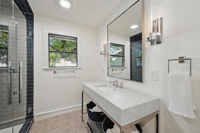 full bathroom featuring baseboards, tile patterned flooring, a stall shower, and vanity