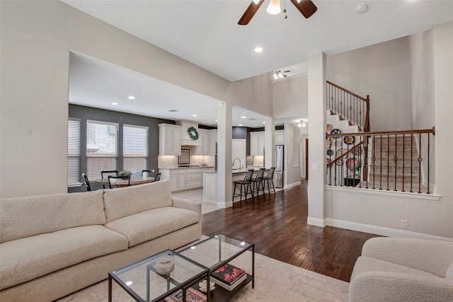 living room with wood finished floors, baseboards, stairway, recessed lighting, and a ceiling fan