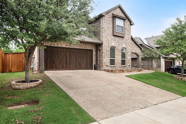 view of front of property featuring fence, an attached garage, brick siding, a front yard, and concrete driveway