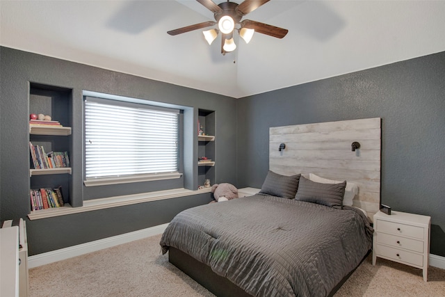 carpeted bedroom with baseboards, a textured wall, and ceiling fan