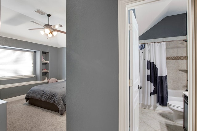bedroom with visible vents, a ceiling fan, lofted ceiling, and light tile patterned flooring