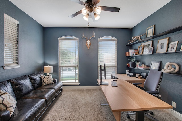 office with carpet floors, a ceiling fan, baseboards, and a textured wall