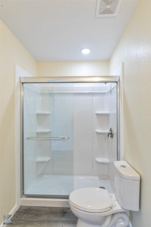 415 Sweetwater Rd, Bronte, TX 76933 - full bathroom with a stall shower, toilet, wood finished floors, and visible vents