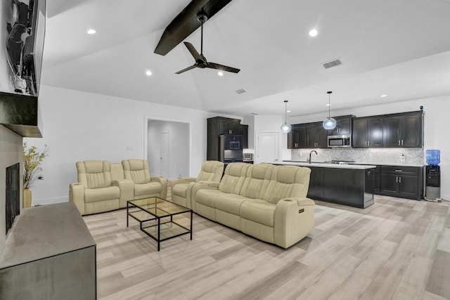 living room featuring recessed lighting, ceiling fan, vaulted ceiling with beams, and light wood-style floors