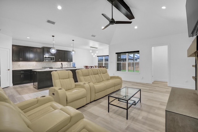 living room featuring visible vents, recessed lighting, light wood-style floors, and ceiling fan with notable chandelier