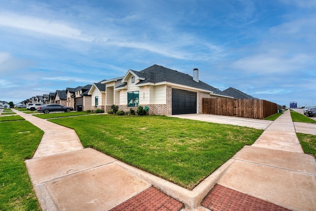 view of front facade featuring a garage, a front lawn, fence, brick siding, and concrete driveway