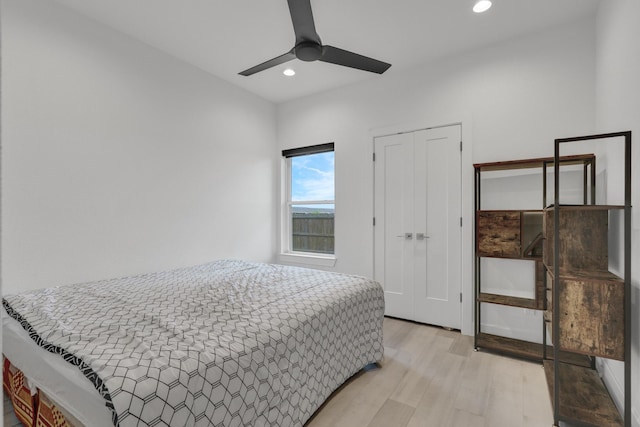 bedroom with recessed lighting, a ceiling fan, a closet, and light wood-style floors