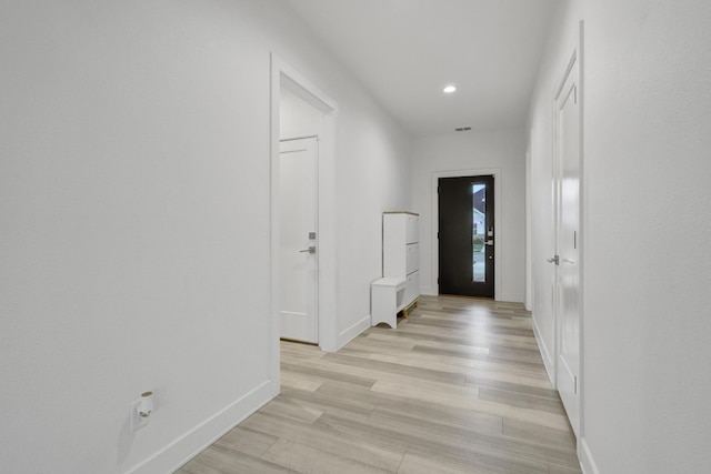 corridor with baseboards, recessed lighting, light wood-style flooring, and visible vents