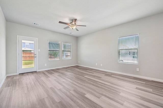unfurnished room with visible vents, baseboards, ceiling fan, and light wood-type flooring