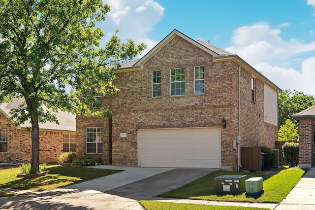 traditional-style house with brick siding, a garage, and driveway