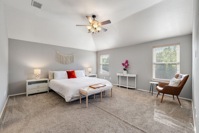 carpeted bedroom featuring visible vents, baseboards, ceiling fan, and vaulted ceiling