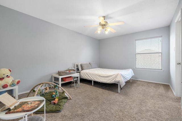 carpeted bedroom featuring baseboards and a ceiling fan