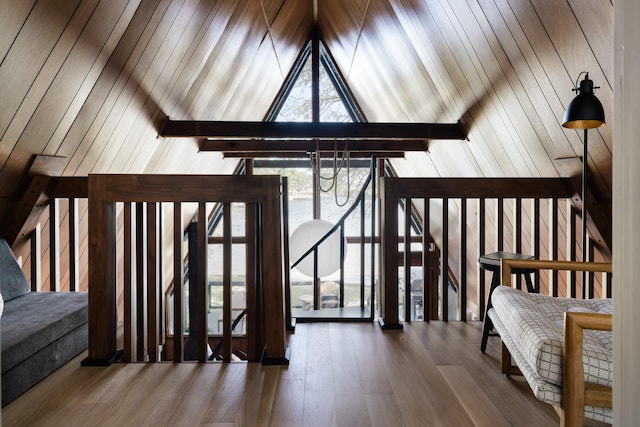 bonus room featuring vaulted ceiling with beams and wood finished floors