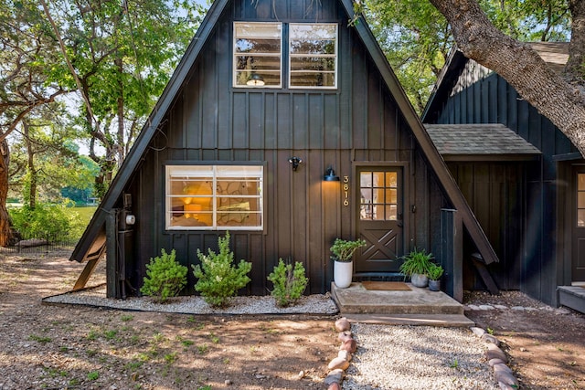 view of front of property with board and batten siding and roof with shingles