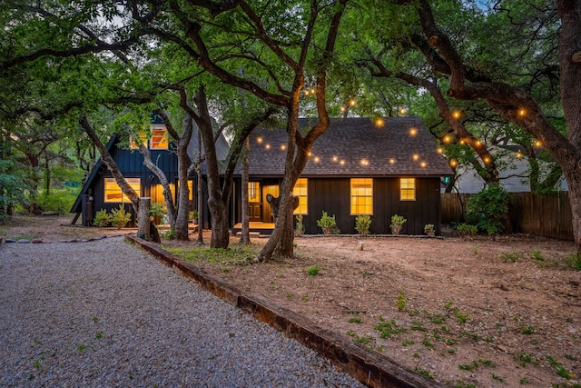 view of front of property featuring board and batten siding and fence