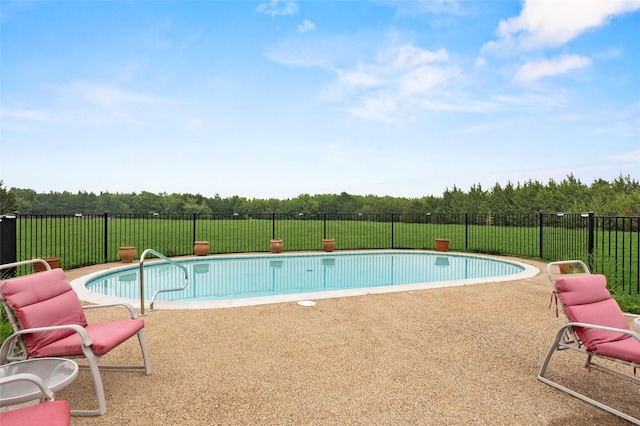 view of swimming pool with a fenced in pool, fence, a yard, and a patio