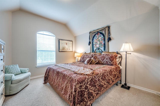bedroom featuring baseboards, carpet, and vaulted ceiling