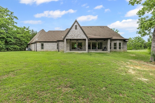 11374 Texas Highway 154 S, Yantis, TX 75497 - rear view of house featuring a yard, brick siding, ceiling fan, and a patio