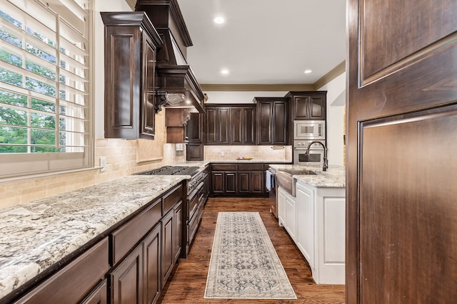 11374 Texas Highway 154 S, Yantis, TX 75497 - kitchen featuring crown molding, dark brown cabinets, dark wood-type flooring, stainless steel microwave, and a sink