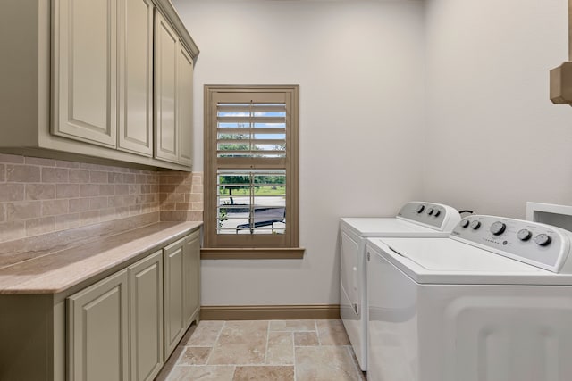 11374 Texas Highway 154 S, Yantis, TX 75497 - laundry room with cabinet space, independent washer and dryer, baseboards, and stone finish floor