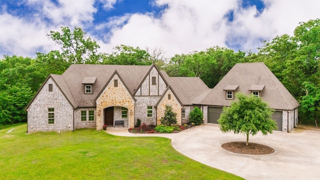 11374 Texas Highway 154 S, Yantis, TX 75497 - tudor-style house featuring brick siding, stone siding, curved driveway, and a front yard