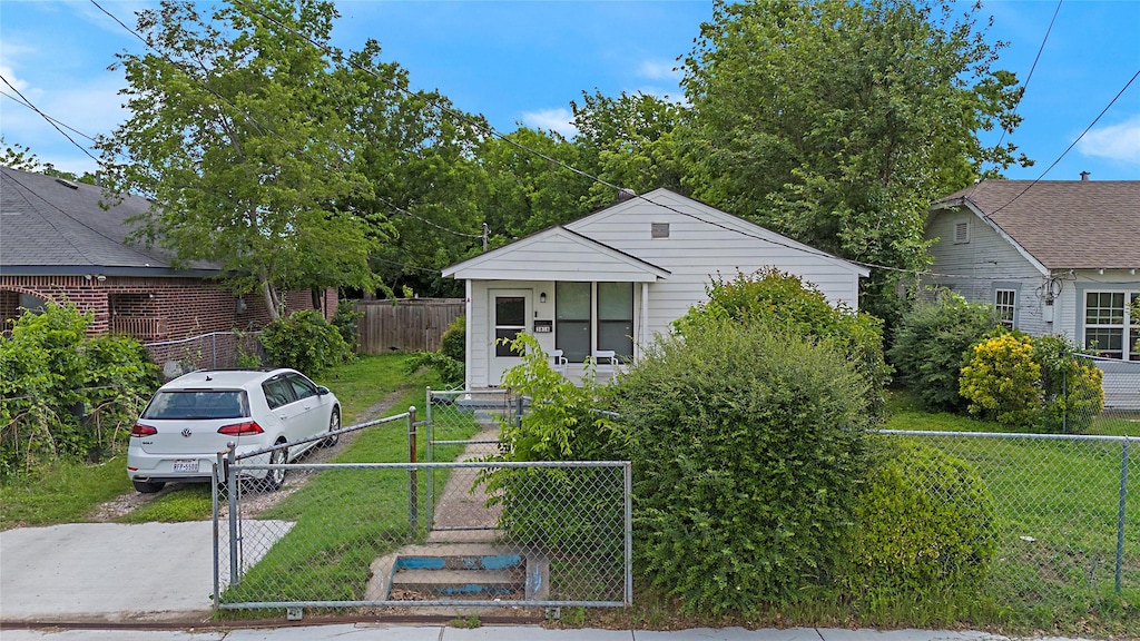 bungalow featuring a gate, fence private yard, and a front yard