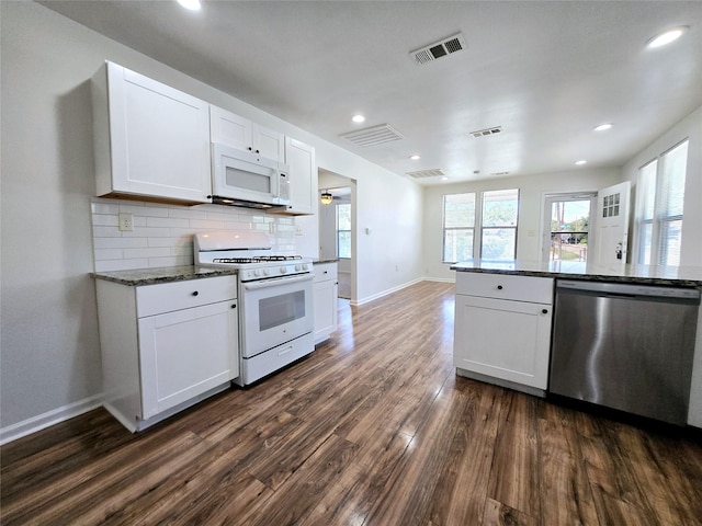 3818 Vilbig Rd, Dallas, TX 75212 - kitchen with white appliances, dark wood finished floors, baseboards, backsplash, and white cabinetry