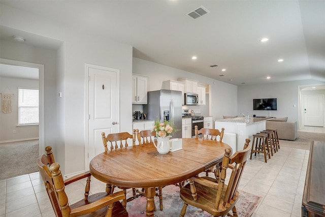 dining space featuring visible vents, light carpet, baseboards, recessed lighting, and light tile patterned floors
