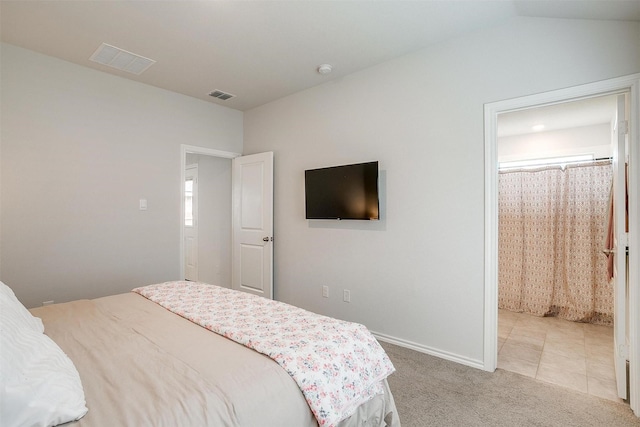 bedroom featuring baseboards, light carpet, vaulted ceiling, and visible vents