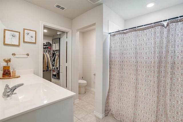 full bath featuring tile patterned floors, toilet, a spacious closet, and visible vents