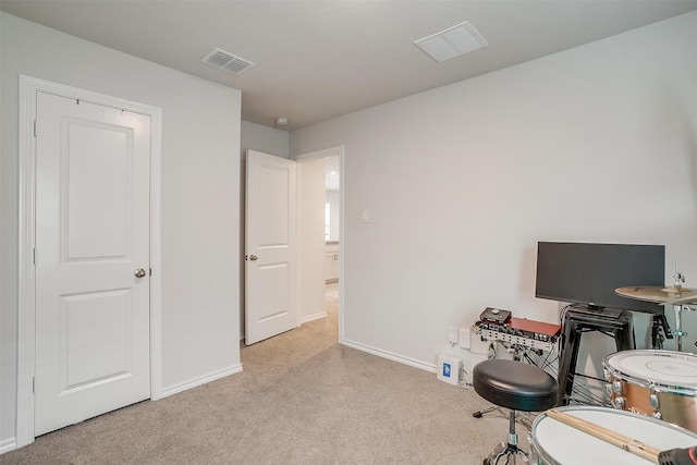 living area with baseboards, visible vents, and light colored carpet