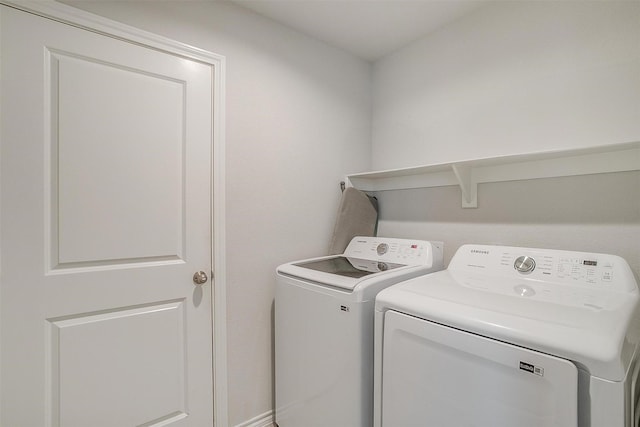 laundry room with separate washer and dryer and laundry area