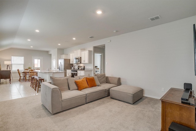 living area with recessed lighting, baseboards, visible vents, and light carpet
