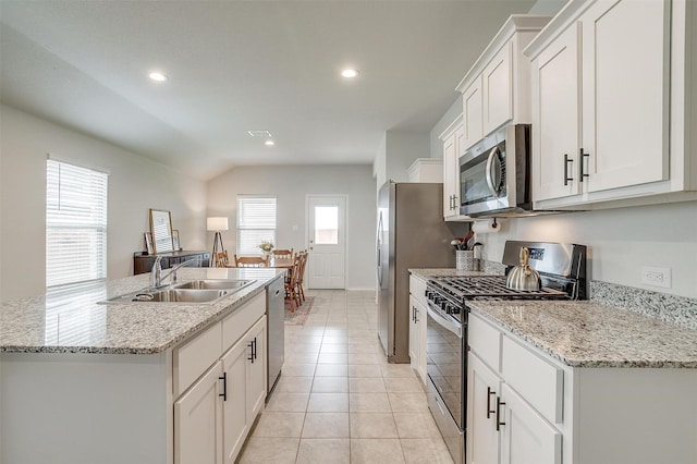 kitchen featuring a kitchen island with sink, white cabinetry, appliances with stainless steel finishes, and a sink