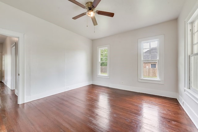 unfurnished room with baseboards, ceiling fan, and wood finished floors