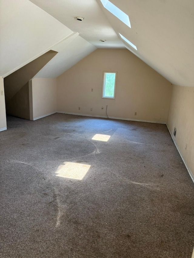 1811 8th St, Wichita Falls, TX 76301 - bonus room featuring carpet floors, a skylight, lofted ceiling, and baseboards
