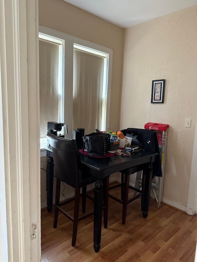dining area featuring baseboards and light wood-style floors