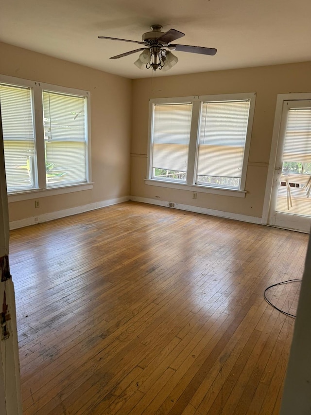 1811 8th St, Wichita Falls, TX 76301 - spare room featuring a ceiling fan, healthy amount of natural light, hardwood / wood-style flooring, and baseboards