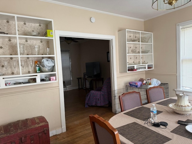 dining space featuring crown molding and wood finished floors