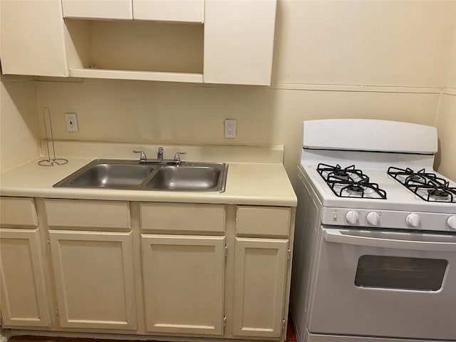 1811 8th St, Wichita Falls, TX 76301 - kitchen with open shelves, white range with gas stovetop, light countertops, and a sink