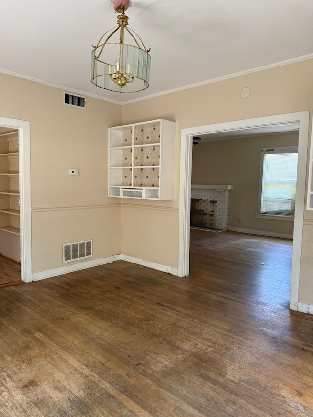 1811 8th St, Wichita Falls, TX 76301 - empty room with crown molding, a chandelier, baseboards, and wood finished floors