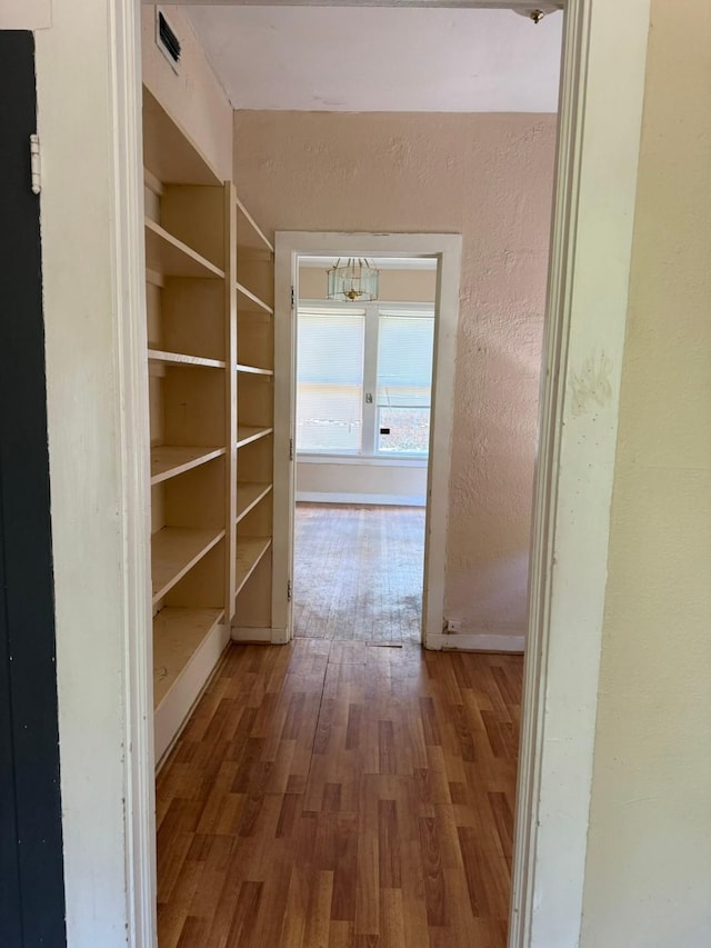 1811 8th St, Wichita Falls, TX 76301 - hallway with wood finished floors, a textured wall, and baseboards