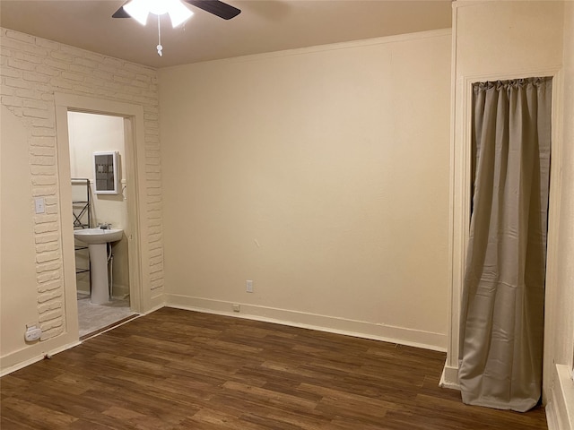 1811 8th St, Wichita Falls, TX 76301 - unfurnished bedroom featuring baseboards, dark wood-style flooring, a sink, and a ceiling fan