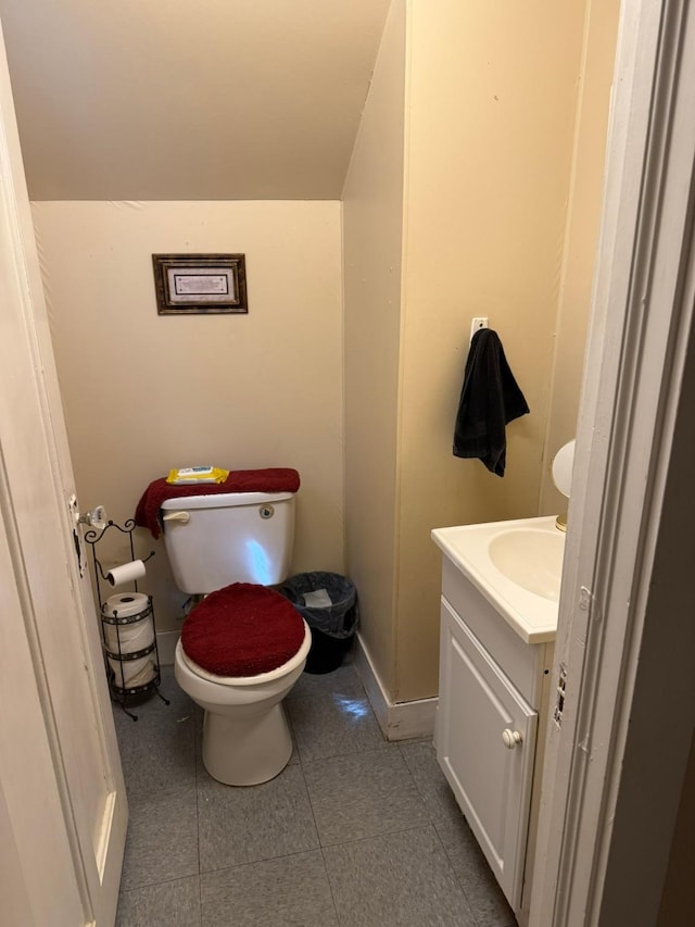 bathroom with vanity, tile patterned flooring, and toilet