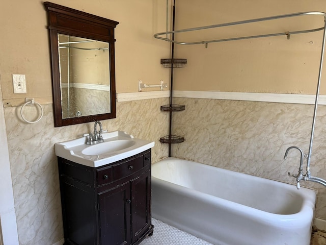 1811 8th St, Wichita Falls, TX 76301 - bathroom featuring a tub to relax in, vanity, tile walls, and a wainscoted wall