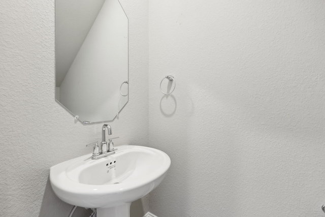bathroom with a sink and a textured wall